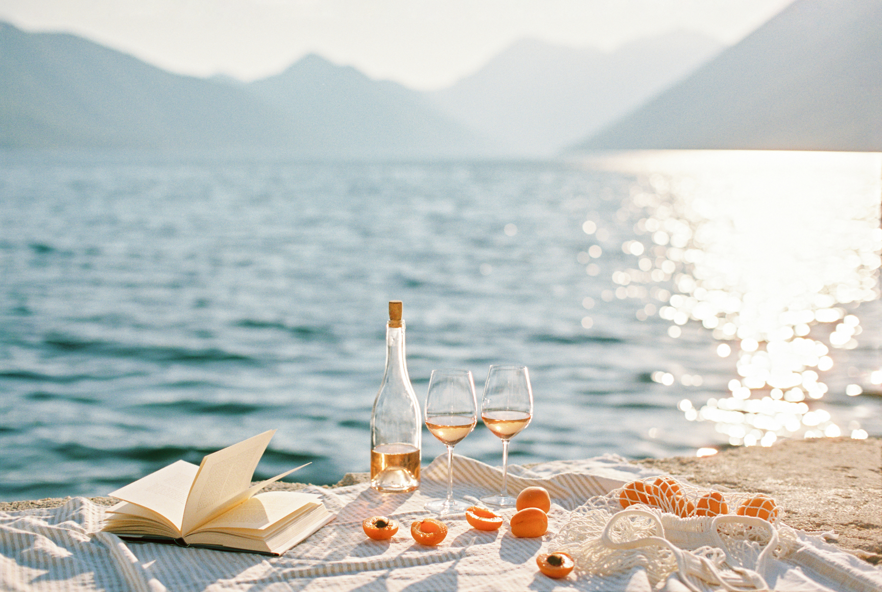 Reading list on the pier with rose wine by Casa de Suna